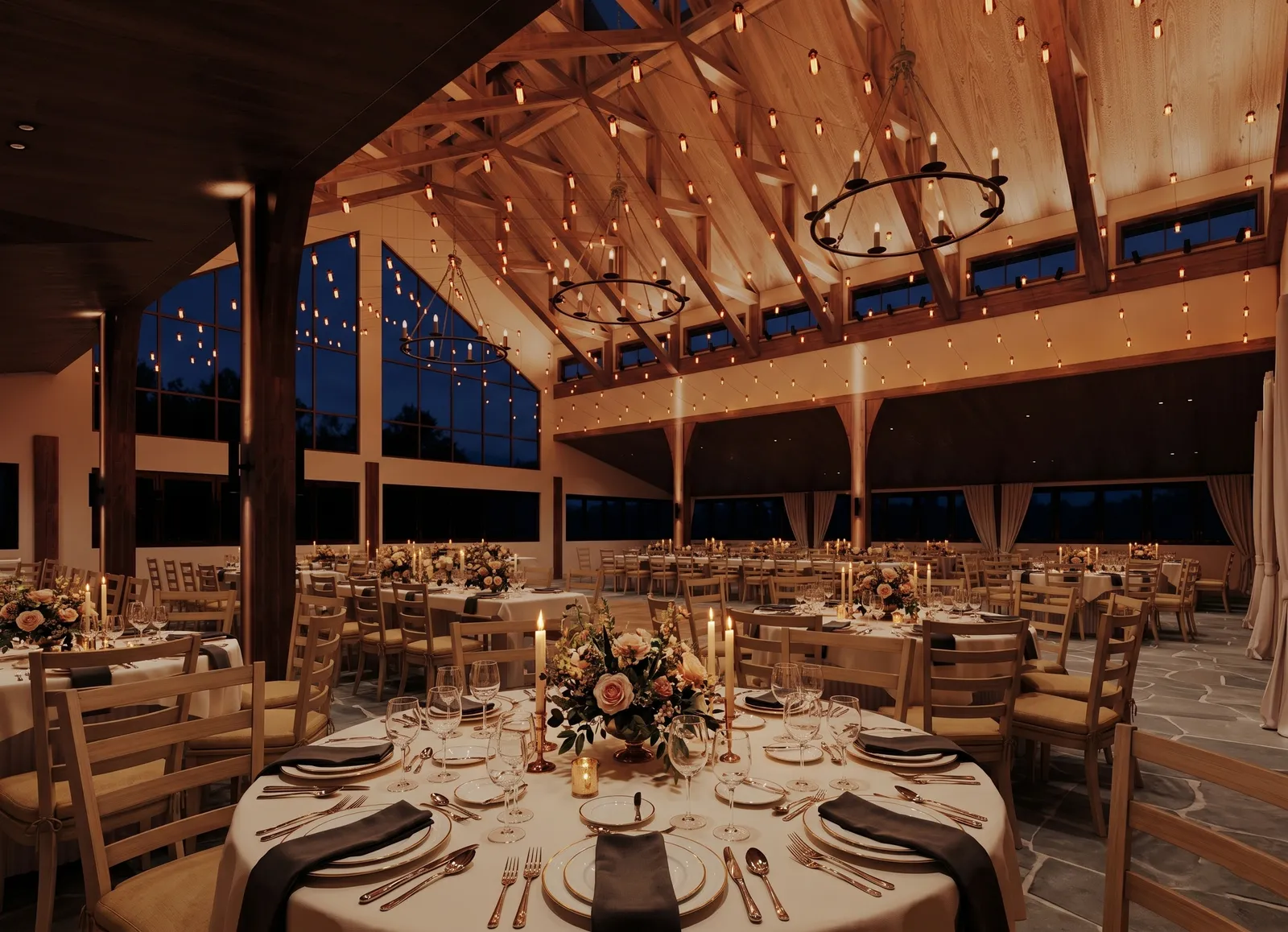 Wedding reception at night under timber trusses and string lights