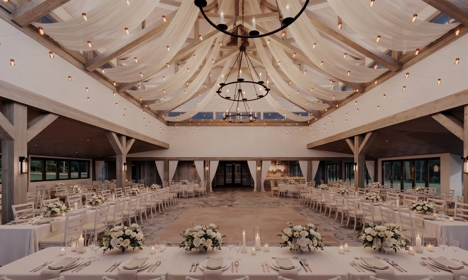 Head table with floral centerpieces at dusk